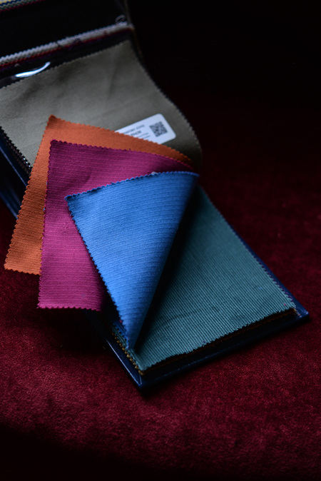 Pattern book showing orange, maroon, blue and green corduroy samples